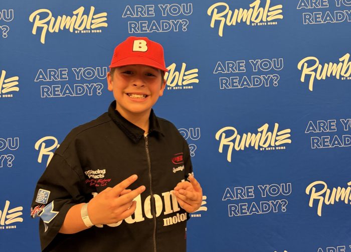 Benji standing in front of Rumble banner